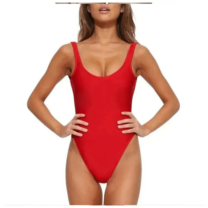 Woman wearing a fashionable open-back one-piece swimsuit, ready for a stylish day at the beach or pool.
