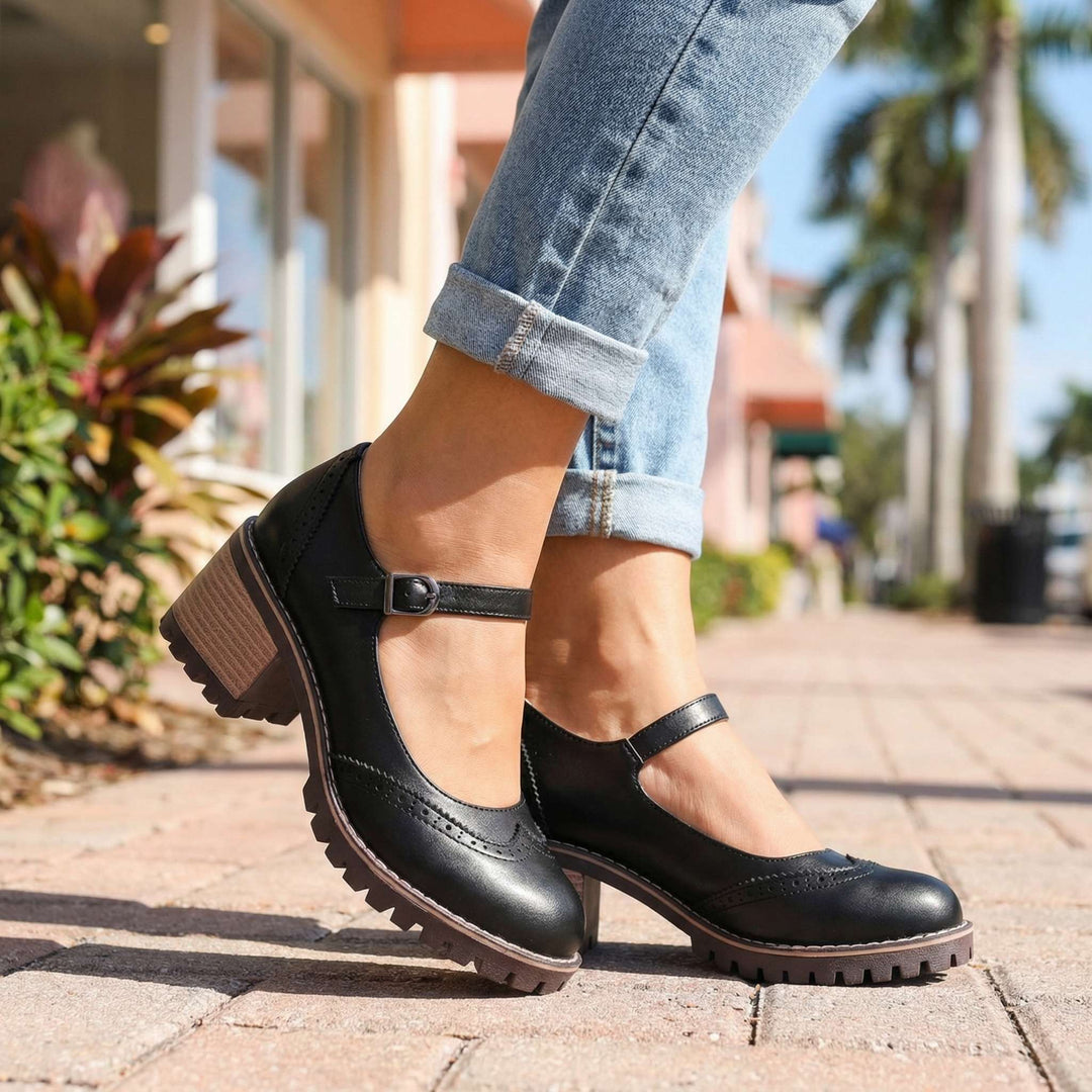 Women's classic T-strap closed-toe heels with comfortable block heel, perfect for all-day wear.