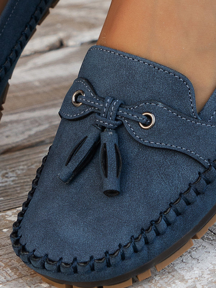 Detail of the supple material of women's classic tassel loafers, comfortable closed-toe slip-on shoes.