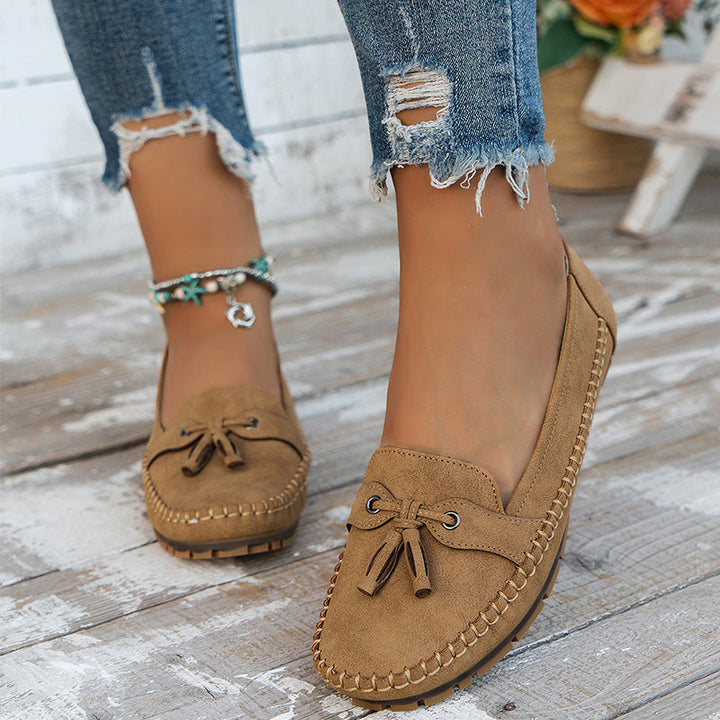 Front view of women's classic tassel loafers, stylish closed-toe slip-ons. Comfortable dress flats.