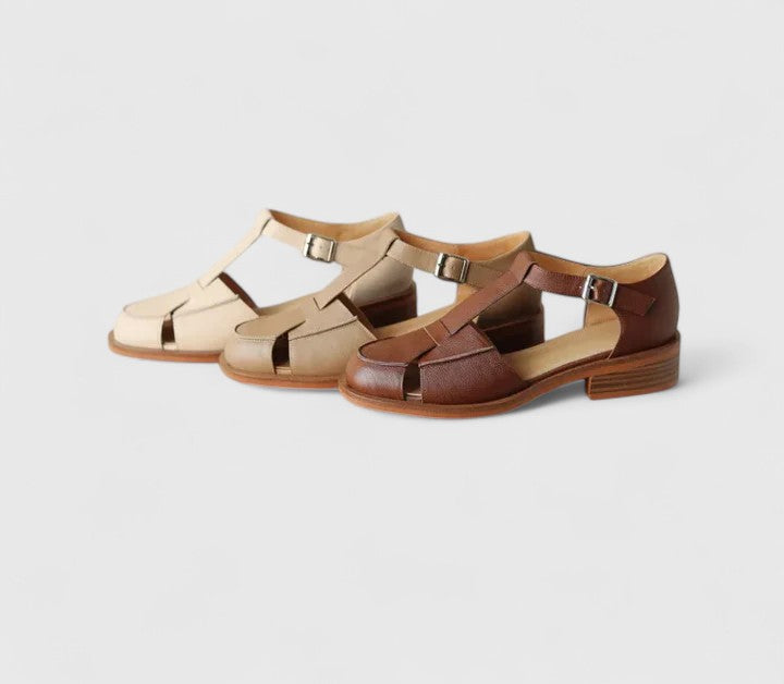 Comfortable brown closed-toe T-strap sandals for women, featuring a secure adjustable strap & block heel.