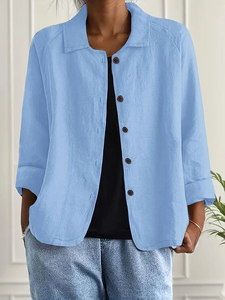 Women's collared button down blouse with three-quarter sleeves. Elegant and versatile for work or casual wear.