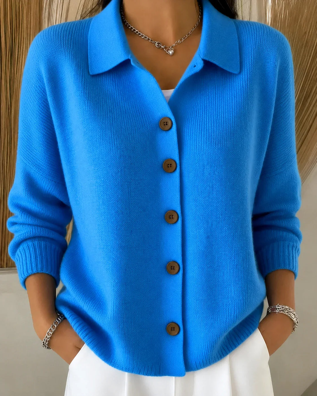 Women's collared button-front cardigan sweater. Versatile, long-sleeve knit for casual or elegant layering.