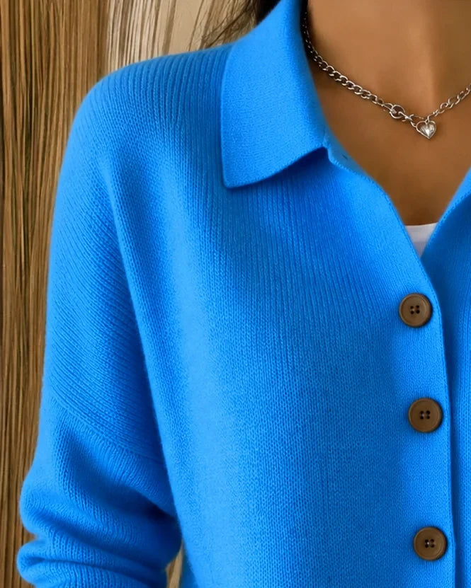 Stylish blue women's collared button-front cardigan sweater. Perfect long-sleeve layering top for cozy comfort.