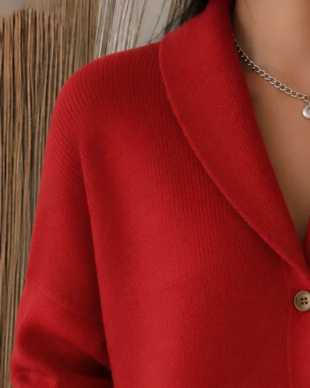 Cozy orange women's collared button-front cardigan sweater. Long-sleeve knit, ideal for layering and comfort.