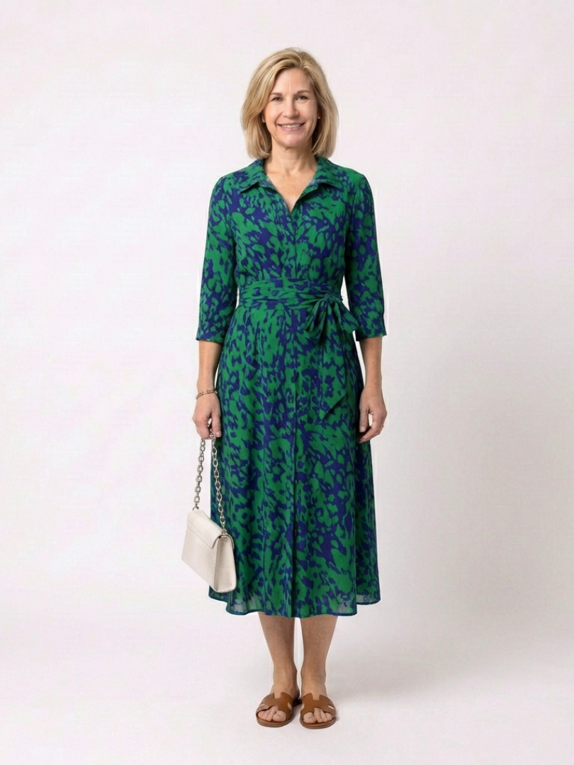 Sophisticated women's midi dress with a collared design, long sleeves, and a flattering waist tie detail.