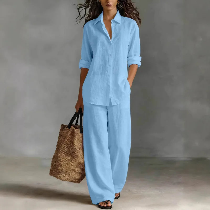 Relaxed fit women's two-piece set with collared long sleeve shirt & wide leg pants, featuring side pockets.