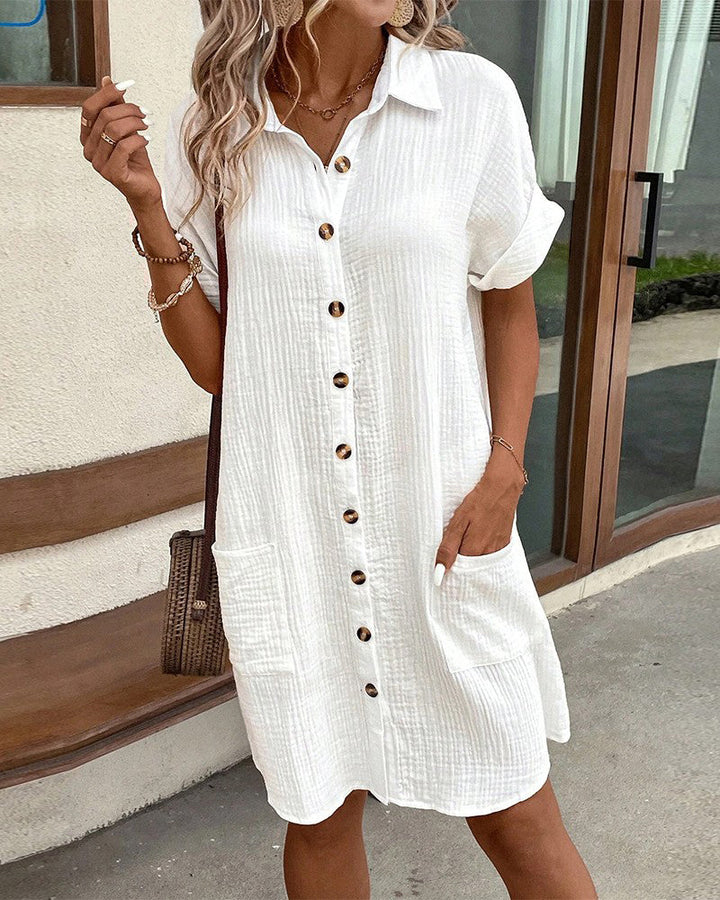 Fashionable collared day dress for women, mini length, with front pockets.