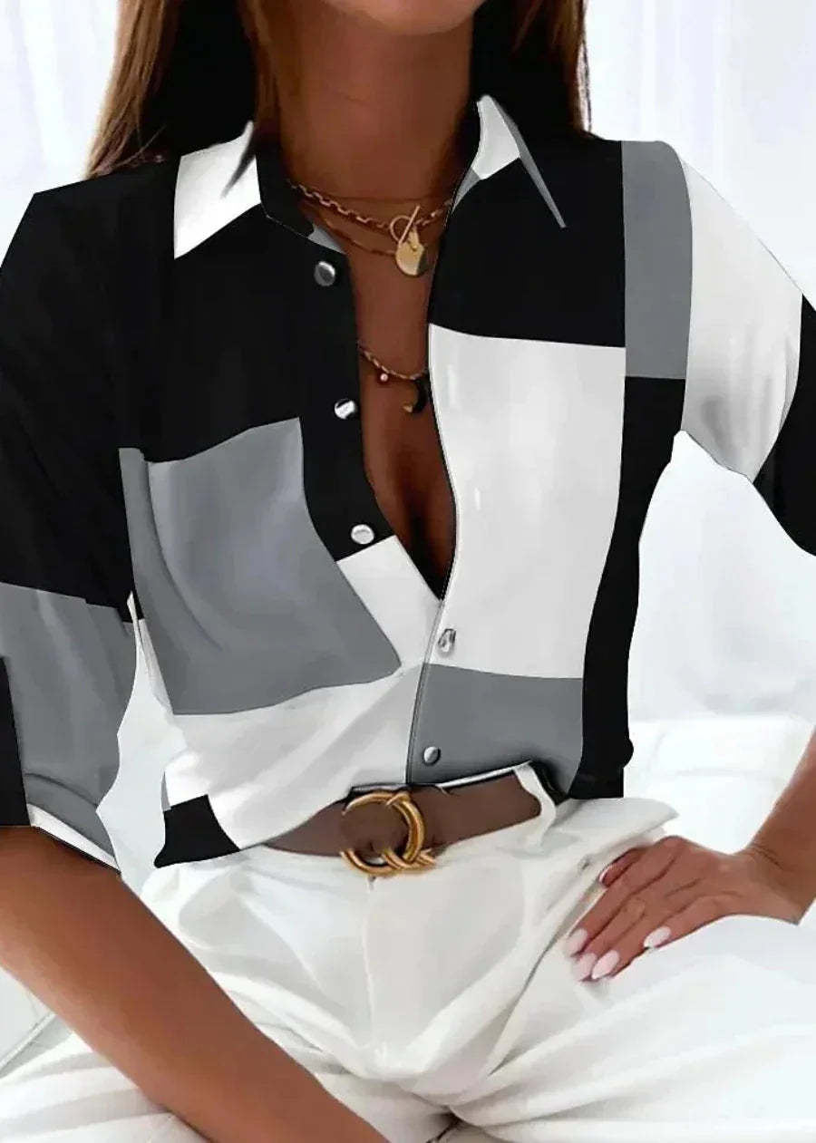 Trendy women's abstract print blouse. Stylish color-block design, 3/4 sleeves, and collared button-down.