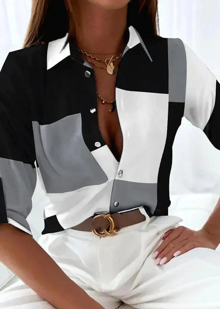 Trendy women's abstract print blouse. Stylish color-block design, 3/4 sleeves, and collared button-down.