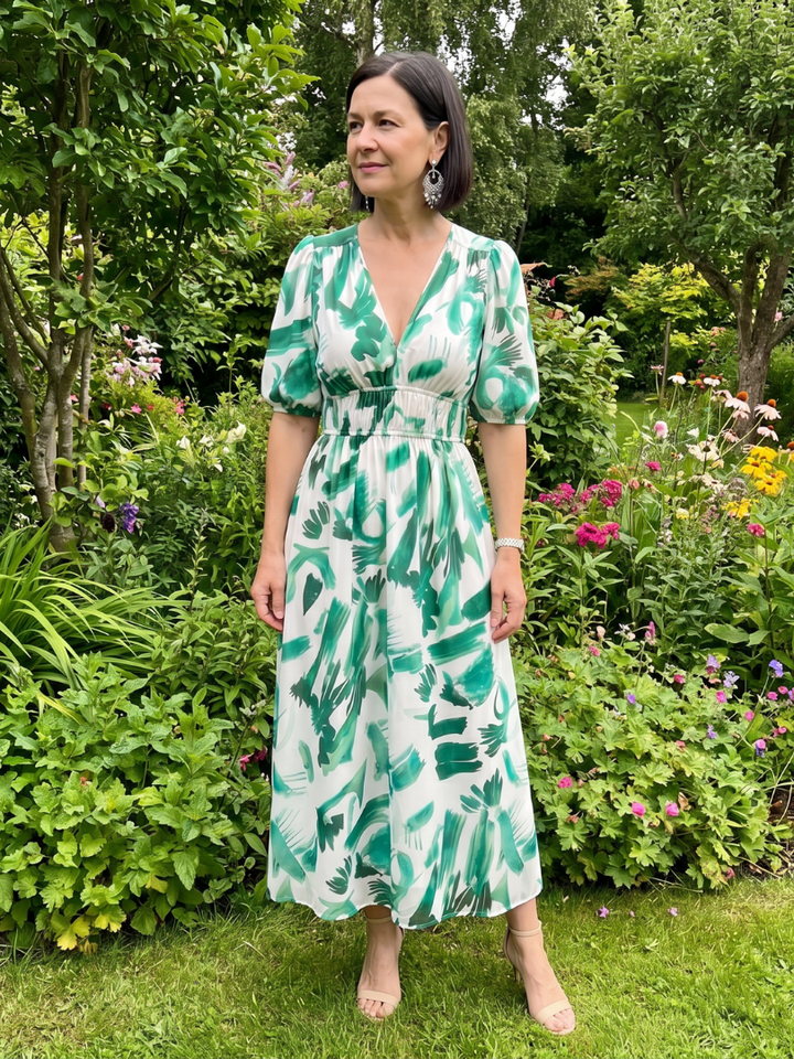 Flowy women's abstract print midi dress with elegant puff sleeves and a comfortable V-neck design.