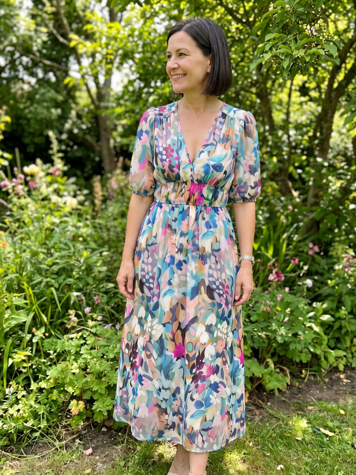 Women's elegant abstract print midi dress, with chic puff sleeves, a flattering V-neck, ideal for fashion.
