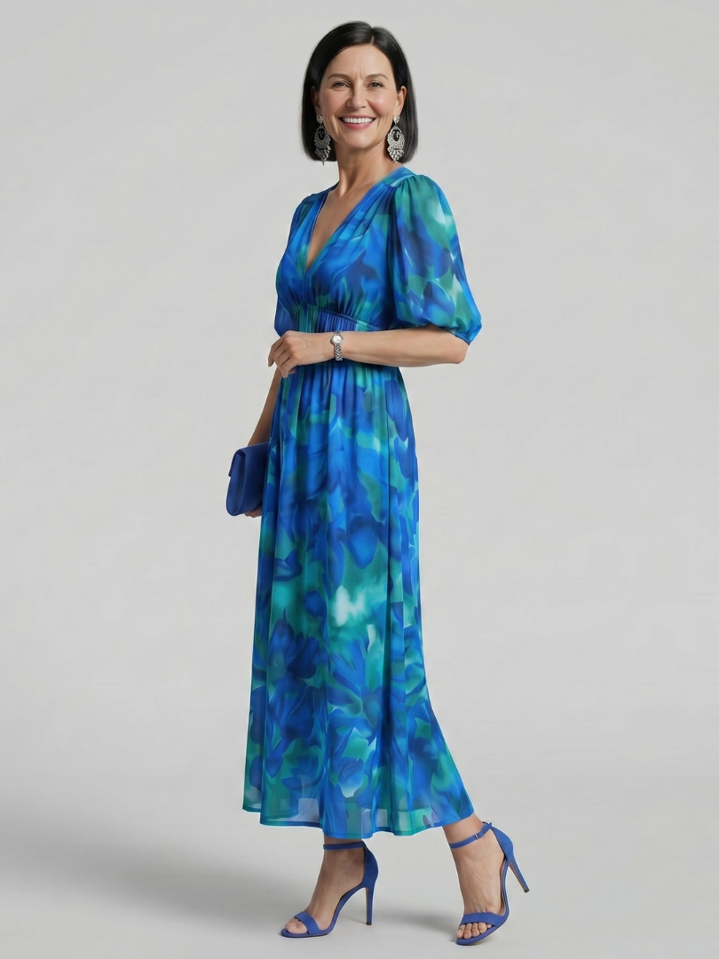 Elegant women's flowy midi dress with abstract print, V-neck, and stylish puff sleeves for a sophisticated look.