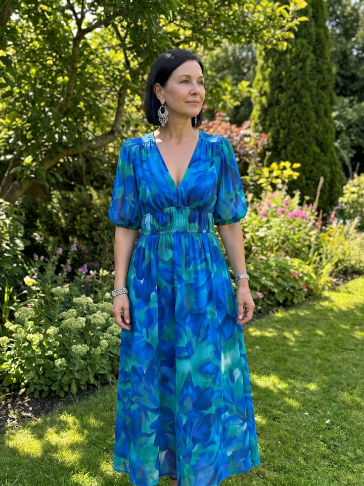 V-neck abstract print midi dress for women, featuring trendy puff sleeves and a comfortable flowy fit.