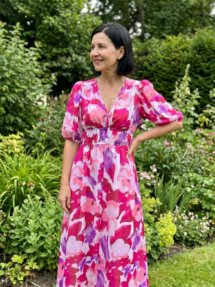 Vacation-ready women's abstract print midi dress with puff sleeves, a stylish V-neck summer outfit.