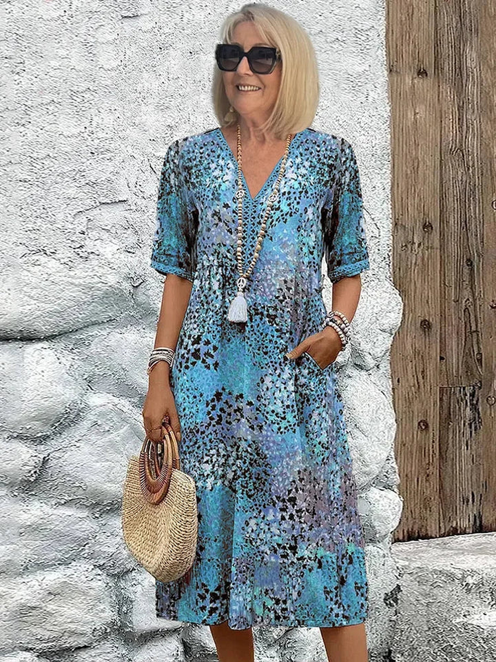 Flowy women's abstract midi dress, V-neck, 3/4 sleeves. Casual elegant day-to-night or vacation wear with pockets.
