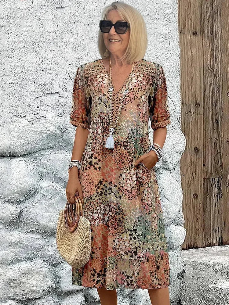 Stylish women's summer midi dress, colorful abstract print, V-neck, 3/4 sleeves. Ideal for casual elegant looks.