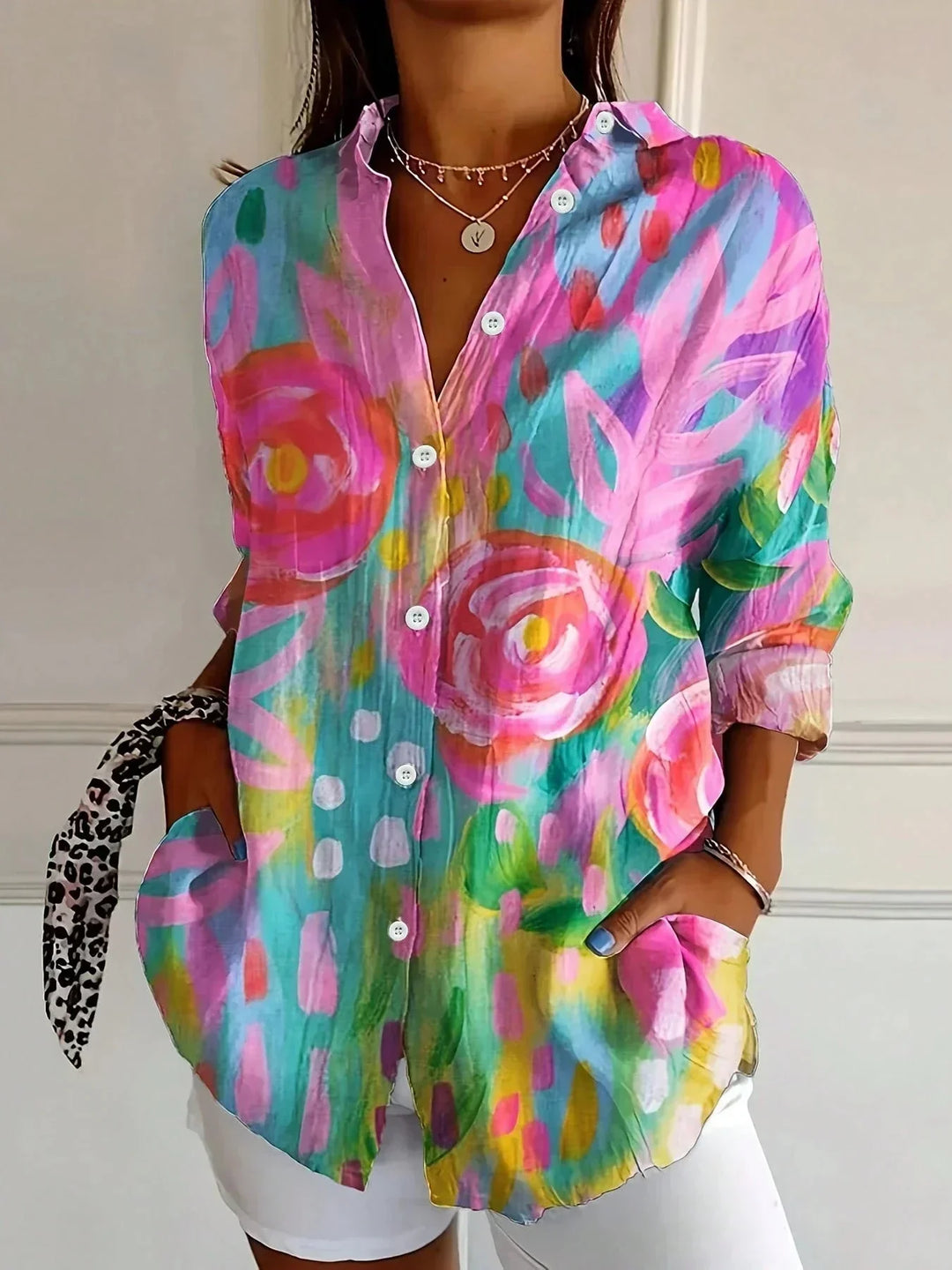 Women's colorful floral long sleeve blouse with a loose fit and button-front. Perfect for casual, everyday wear.
