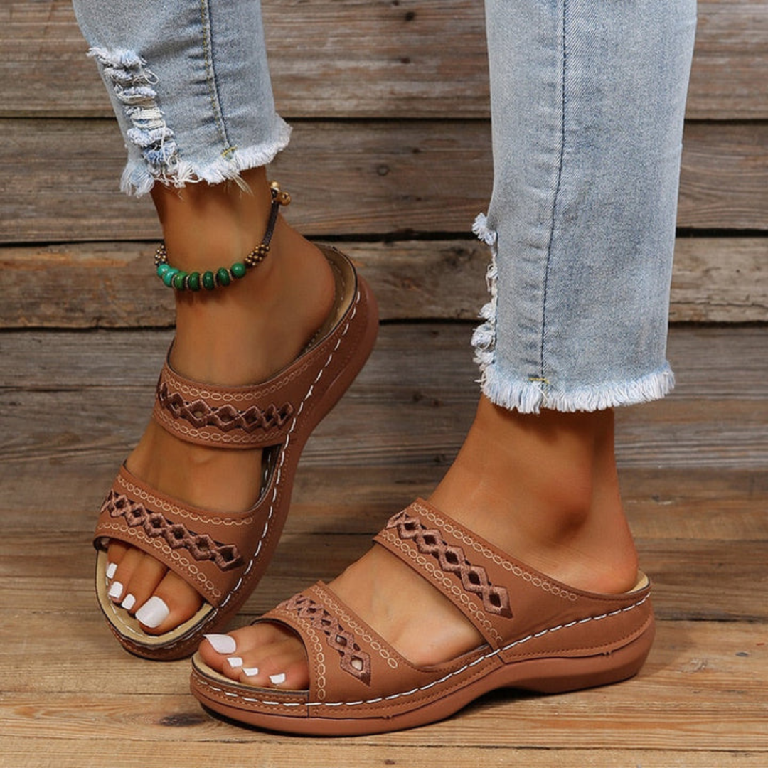 Women's laser cut slide sandals, designed for comfort, arch support, and fashionable summer style.