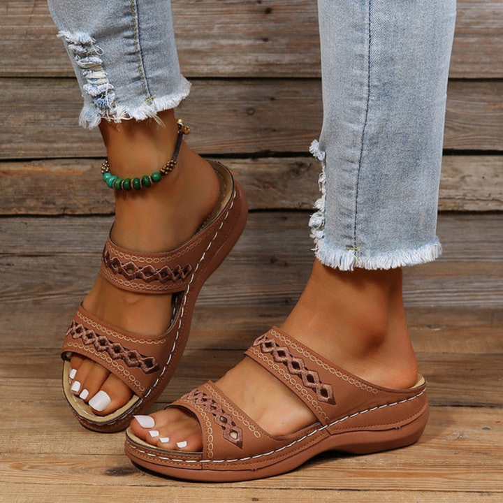 Women's laser cut slide sandals, designed for comfort, arch support, and fashionable summer style.
