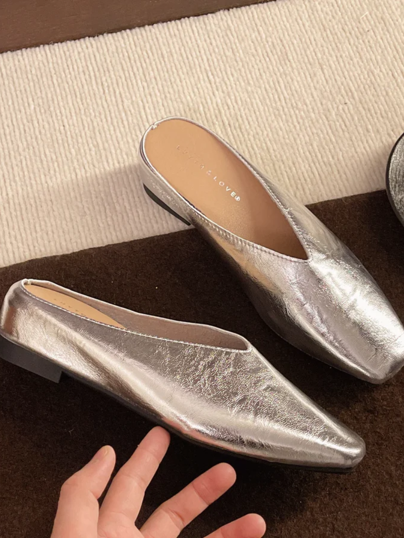 Silver women's comfortable slip-on flats with rounded toe, offering effortless style for versatile everyday wear.