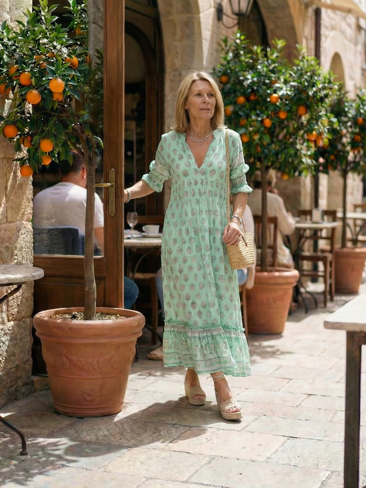 Comfortable women's floral casual dress. Knee-length, three-quarter sleeves, button front. Great for spring/summer wear.