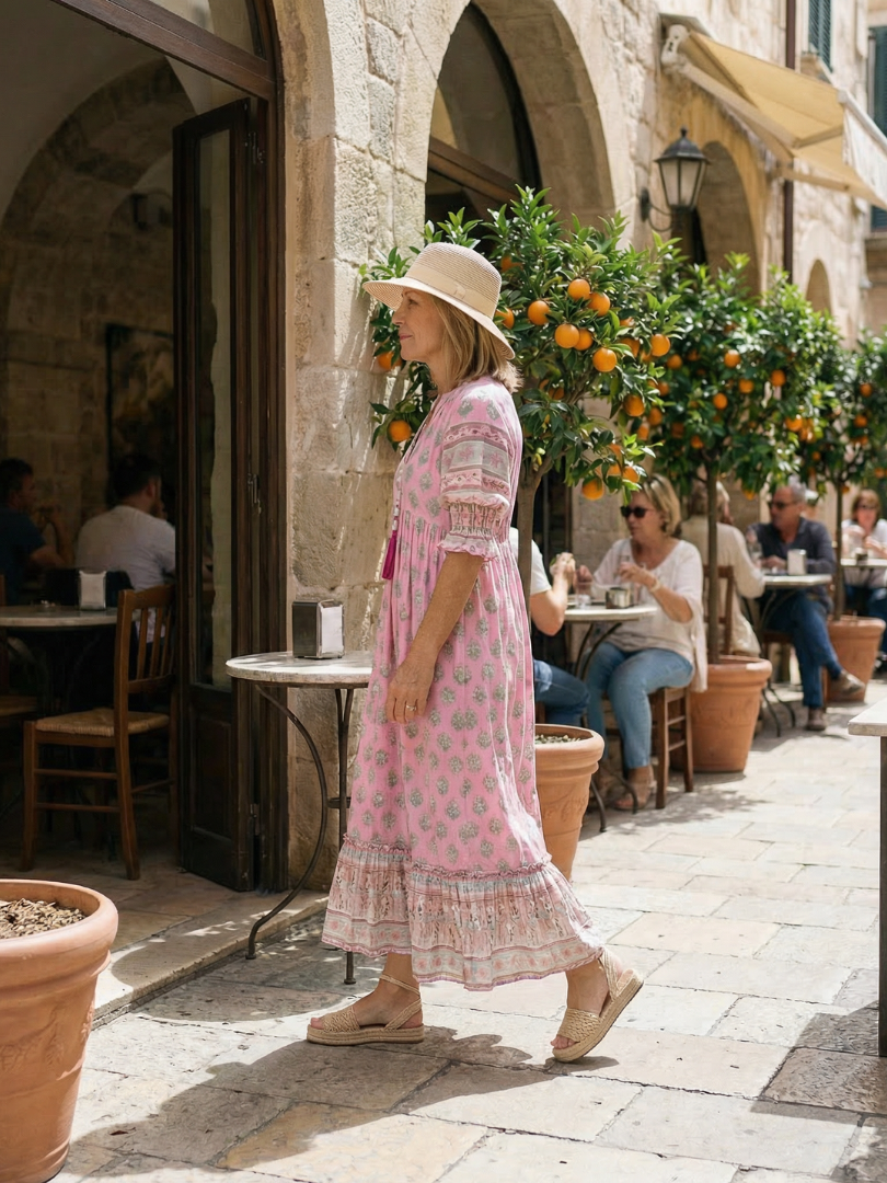 Casual women's button-front floral dress, knee-length with three-quarter sleeves, ideal for market or garden outings.