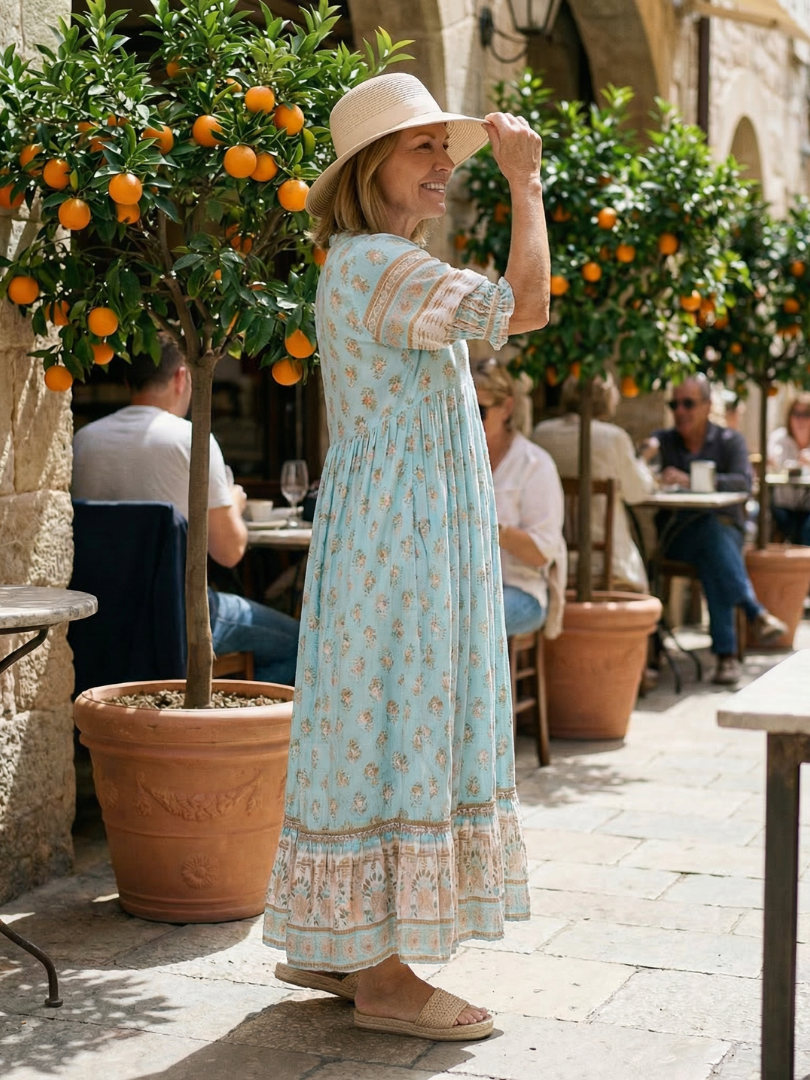 Soft women's casual floral dress, knee-length, button-front, three-quarter sleeves. Great for spring market days.