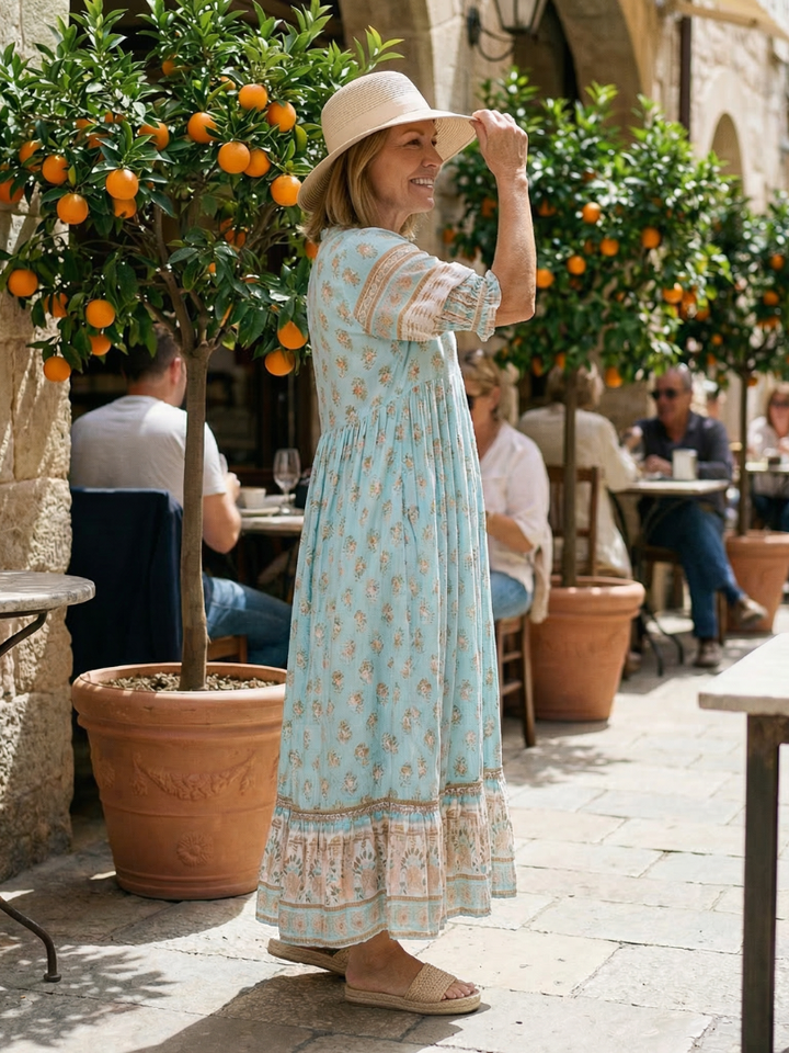 Soft women's casual floral dress, knee-length, button-front, three-quarter sleeves. Great for spring market days.