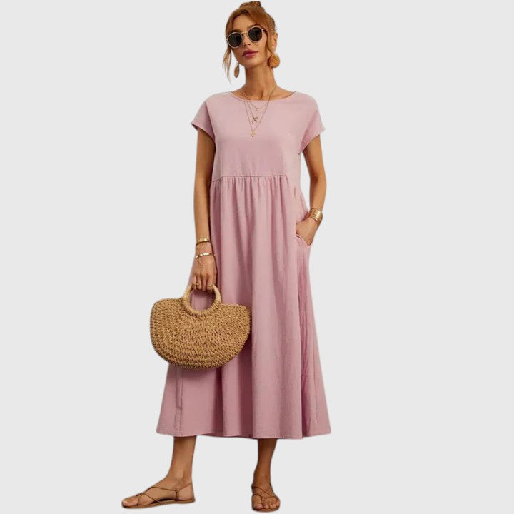 Elegant flowy midi dress for women. Comfortable, short sleeve design with practical pockets for summer.