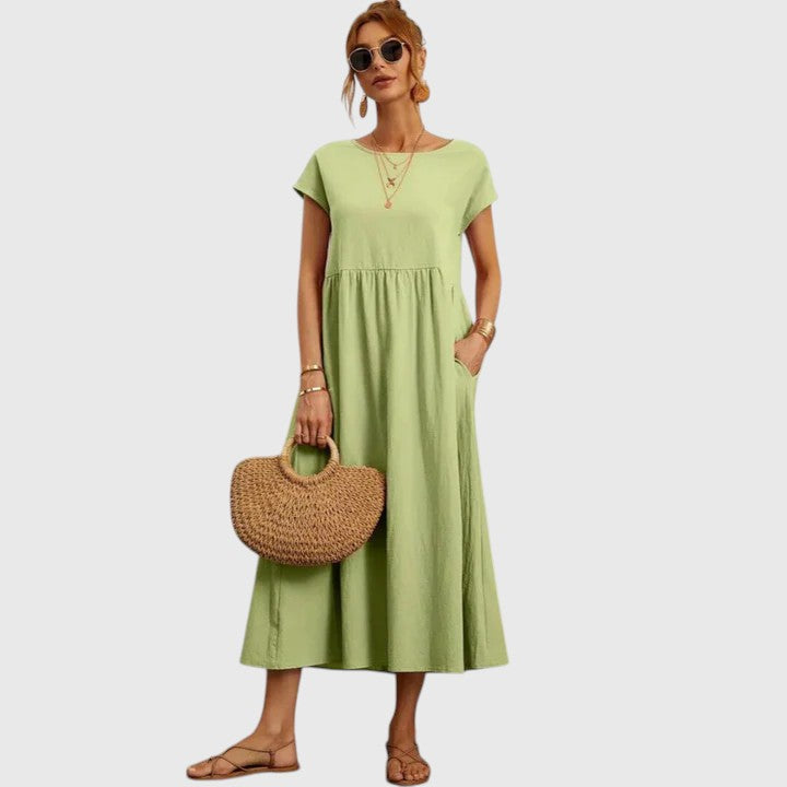 Comfortable women's midi dress with practical pockets. Flowy design for versatile casual summer fashion.