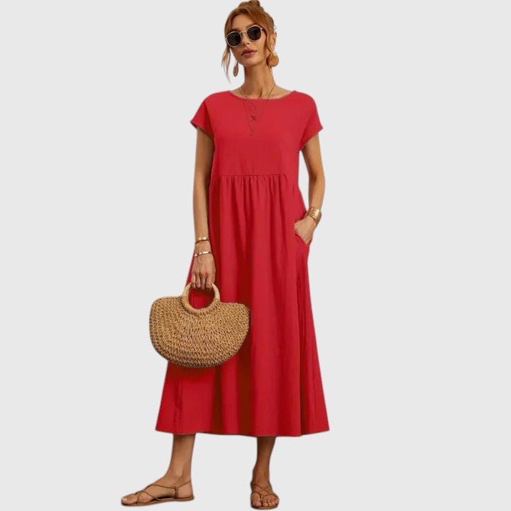 Chic women's flowy midi dress with pockets. Comfortable, short sleeve design for versatile summer style.