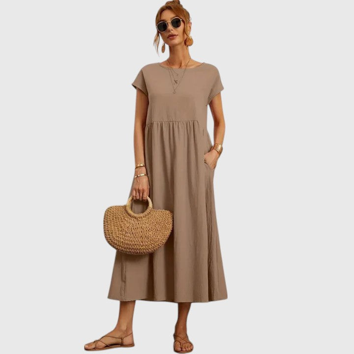 Women's short sleeve midi dress with pockets. Flowy, comfortable, and perfect for versatile casual wear.