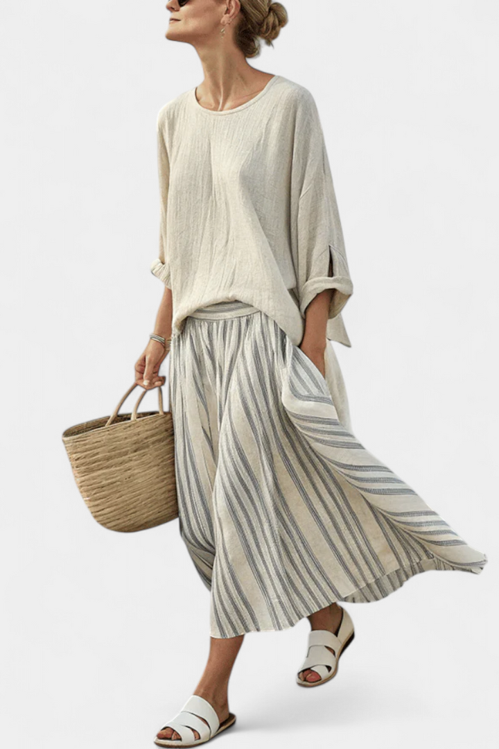 Women's comfortable loose blouse & striped midi skirt set. Chic two-piece for summer vacation & casual elegance.