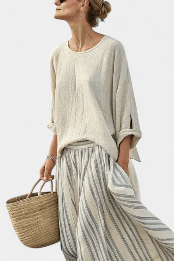 Relaxed fit women's loose blouse & flowing striped midi skirt set. Perfect comfortable two-piece for summer fashion.