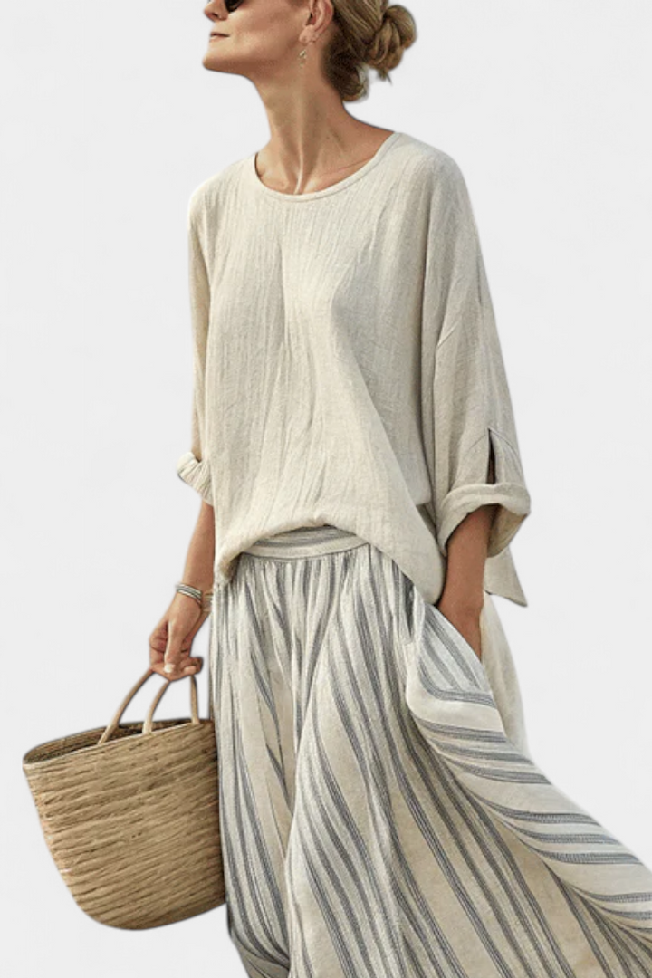 Relaxed fit women's loose blouse & flowing striped midi skirt set. Perfect comfortable two-piece for summer fashion.