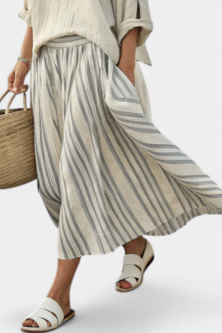 Casual elegant women's two-piece set featuring a loose blouse & striped midi skirt. Ideal for summer & vacation wear.