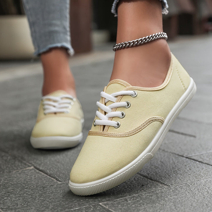 Durable women's low-cut canvas lace-up shoes, offering comfortable support for everyday errands.