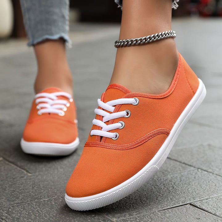 Stylish women's casual canvas sneakers with classic lace-up closure, ideal comfortable everyday footwear.