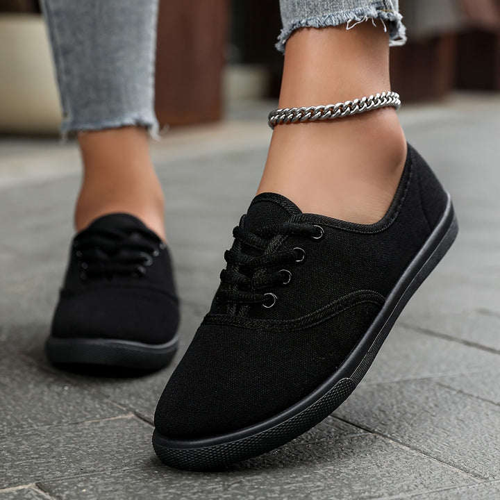Classic women's casual canvas footwear with a low-top design and durable lace-up front for daily comfort.