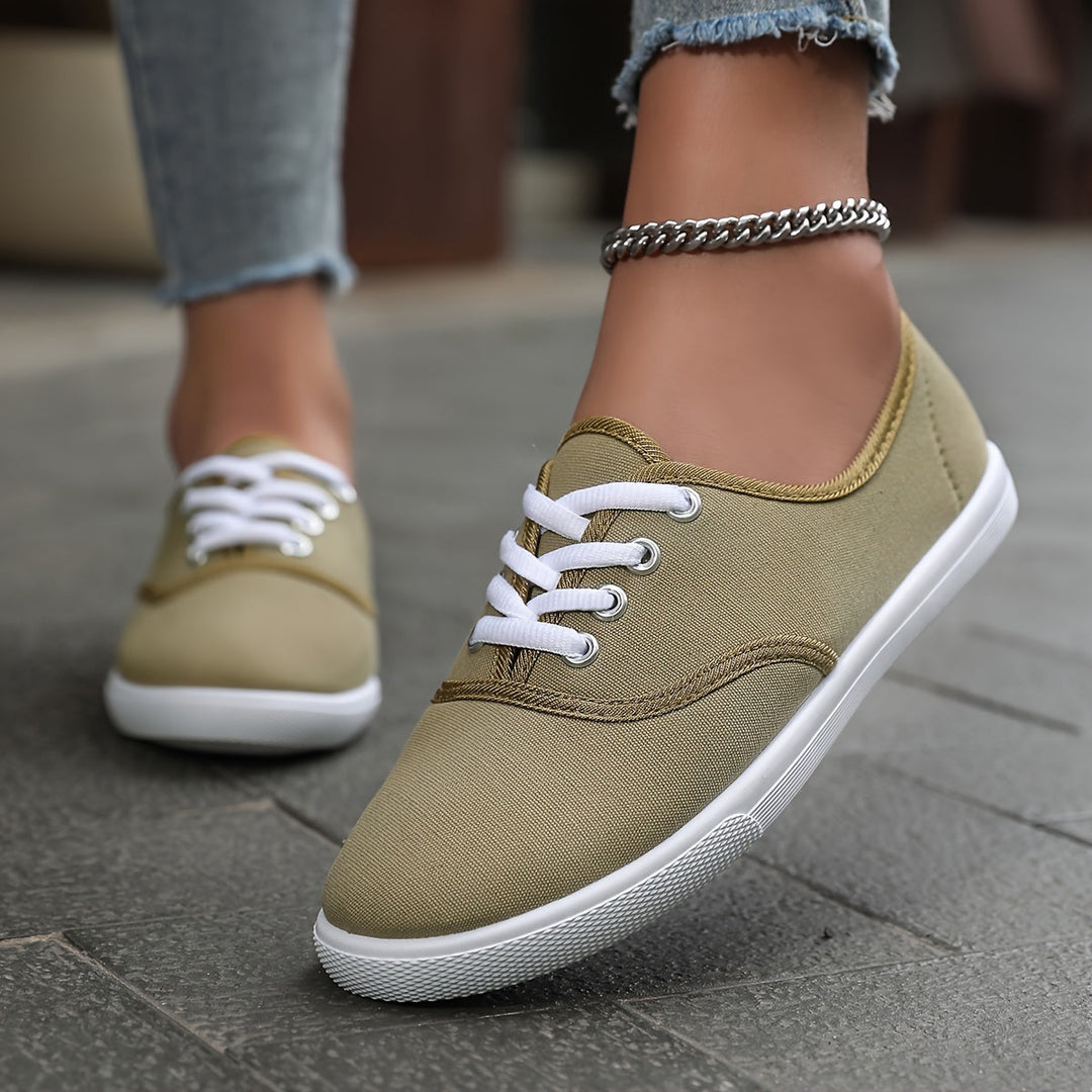 Fashionable women's low canvas lace-up footwear, combining comfort with versatile casual style.