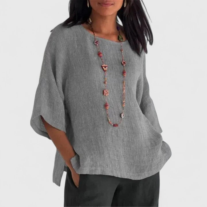 Women's comfortable O-neck blouse with relaxed fit & three-quarter sleeves, perfect for casual summer style.