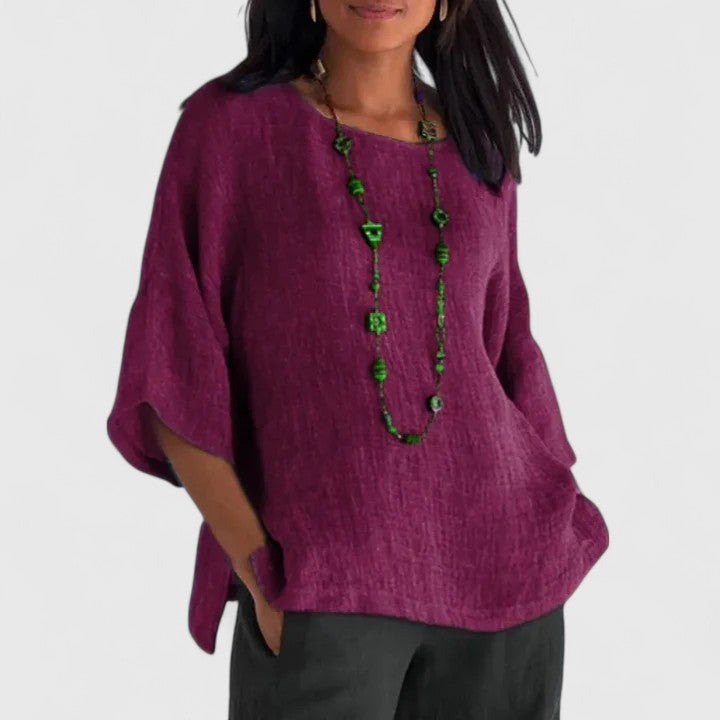 Soft pink women's O-neck blouse, a comfortable top with three-quarter sleeves for easy summer wear.