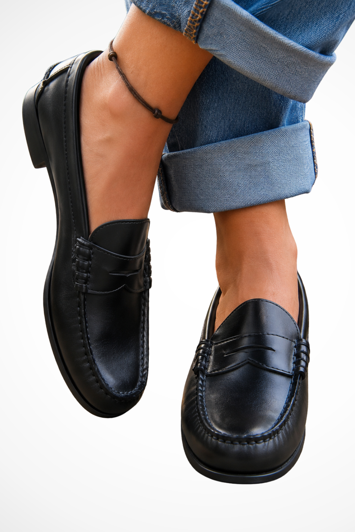 Black orthopedic slip-on penny loafers for women, offering comfortable everyday style and easy wear. Perfect casual shoes.