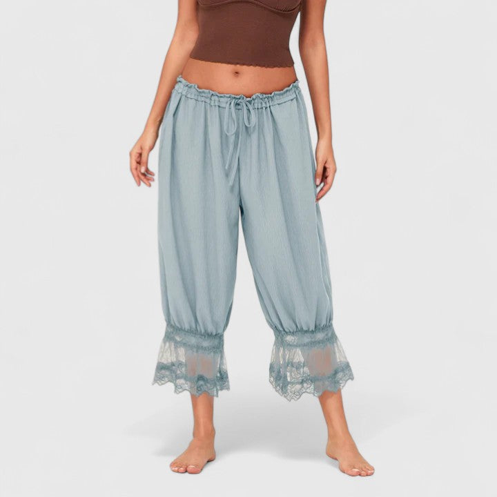 Front view of comfortable women's loose-fit trousers, featuring a distinctive patchwork and lace design.
