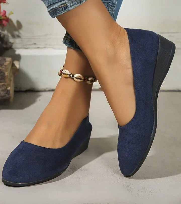 Women's comfortable slip-on low wedge shoes with a stylish round toe, perfect for everyday casual wear.