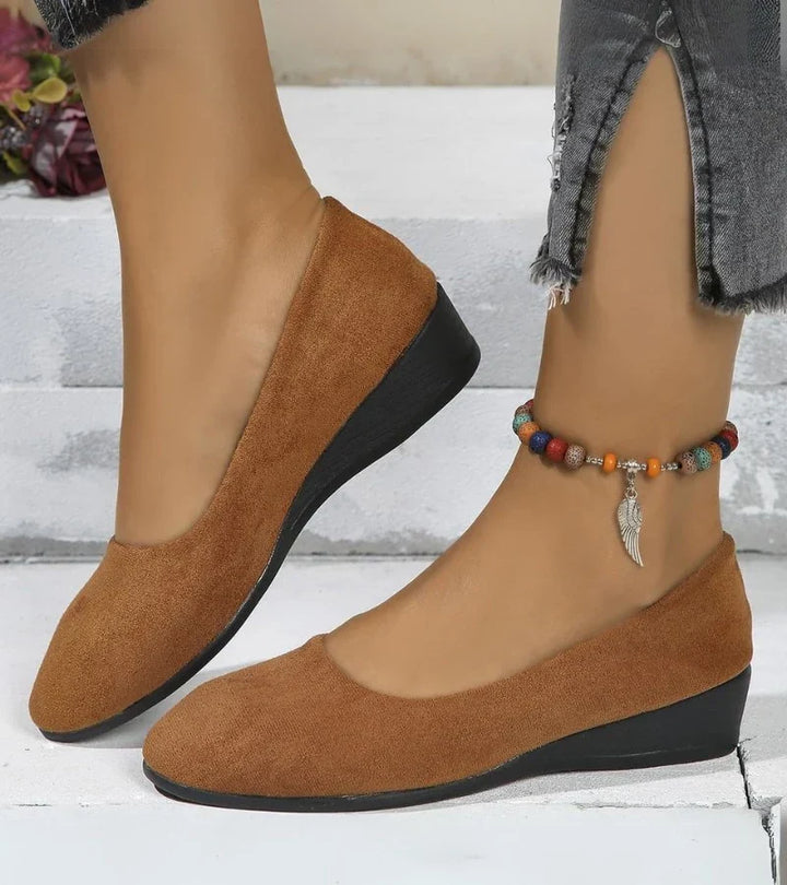 Soft women's slip-on low wedge shoes, featuring a comfortable round toe design for stylish and easy everyday wear.