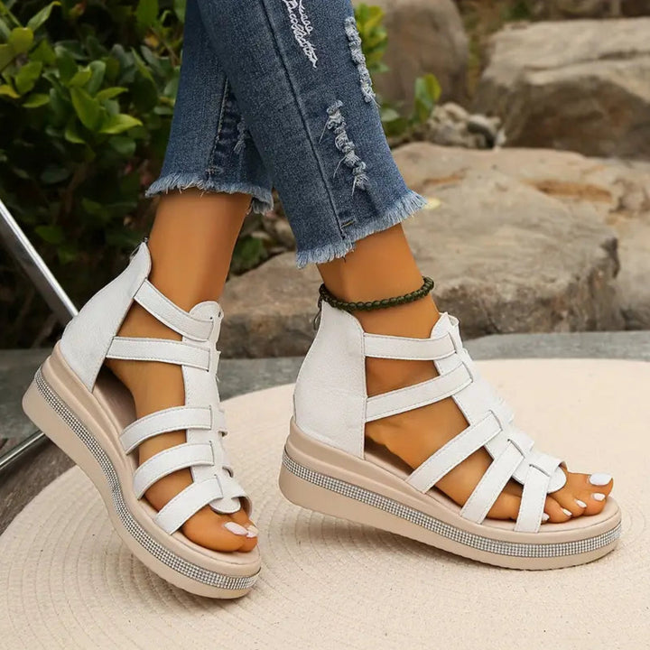 White women's comfortable wedge sandals, perfect for stylish summer outfits & relaxed vacation footwear.