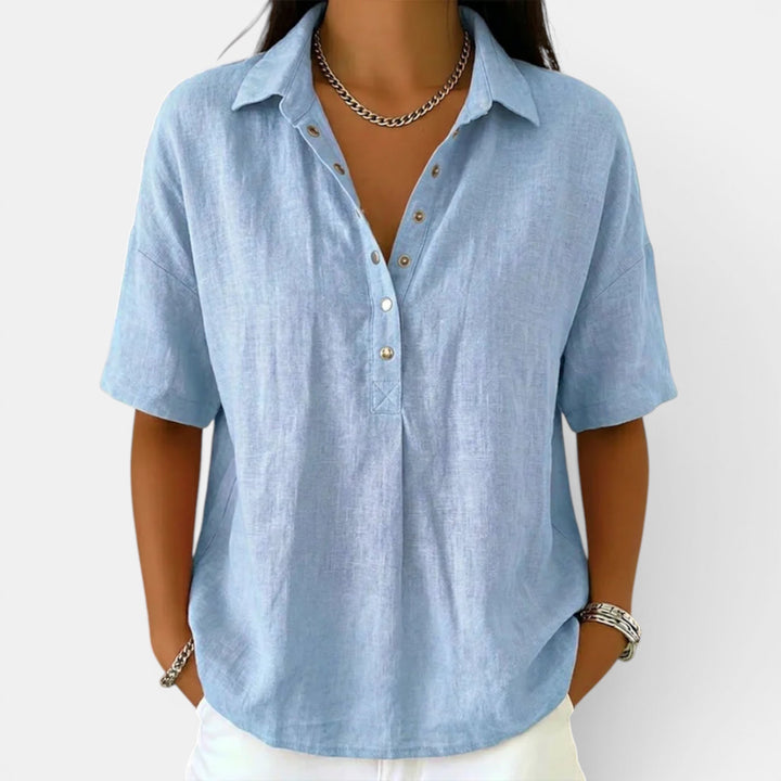 Back view of women's comfortable short sleeve V-neck blouse, offering a relaxed and elegant fit for casual wear.