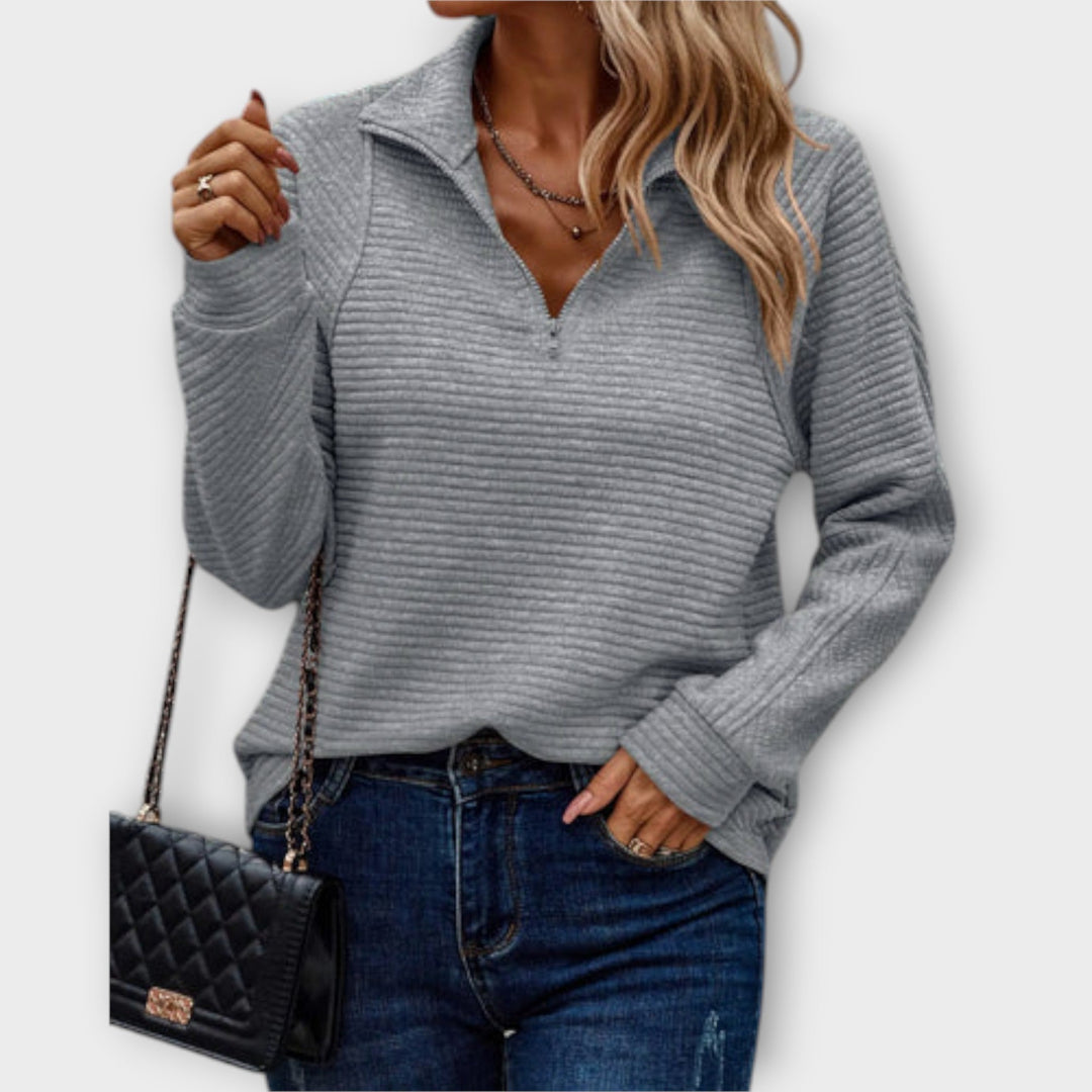 Soft knit V-neck jumper for women, featuring a zipper. Comfortable, long-sleeve pullover, perfect for any occasion.